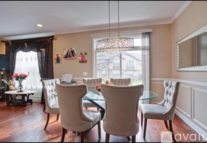 A dining room with a glass table and chairs.