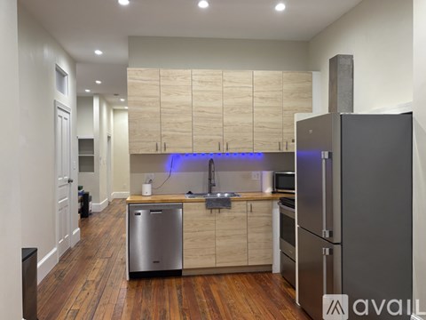 A kitchen with wooden cabinets and stainless steel appliances.