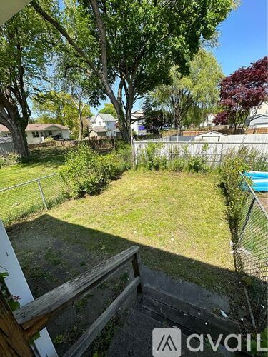 A backyard with a pool and a deck.