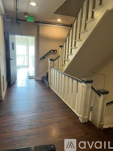 A staircase with a metal railing and wooden steps.