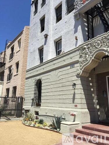 A building with a balcony and a gate in front.