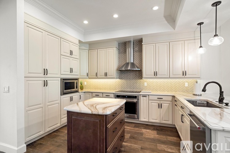 A kitchen with wooden cabinets and a central island.