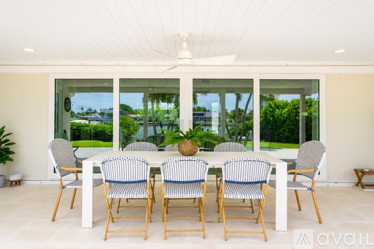 A white dining room with a table and chairs.