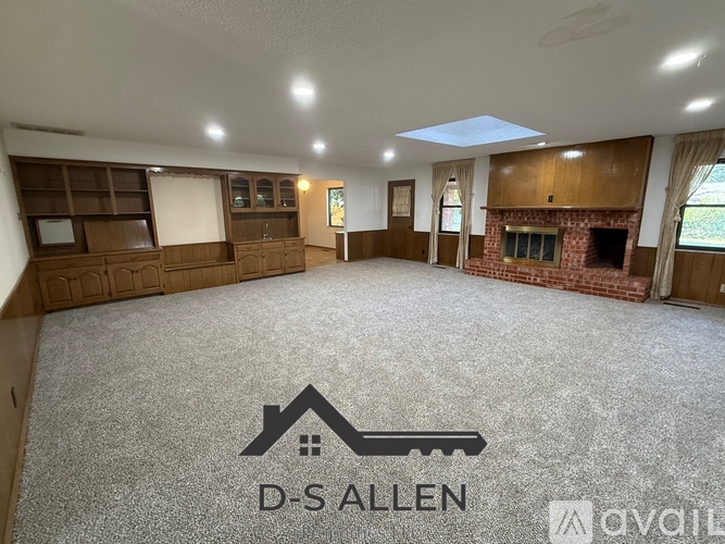 A spacious room with a fireplace and a logo that reads "D-Sallen".