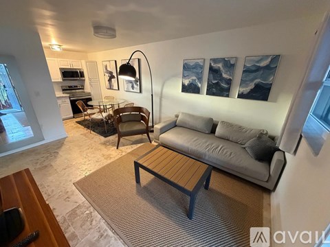 A living room with a grey couch and a wooden coffee table.