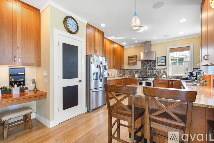 A kitchen with wooden cabinets and a white fridge.