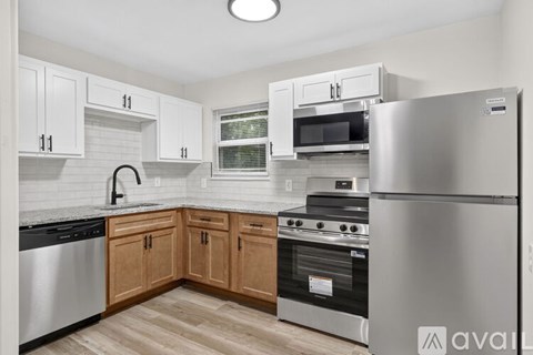 A kitchen with wooden cabinets and stainless steel appliances.