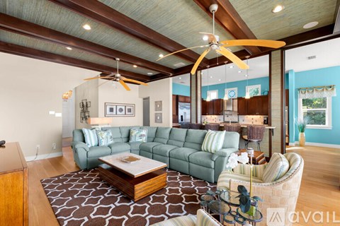 A living room with a green couch and a wooden coffee table.