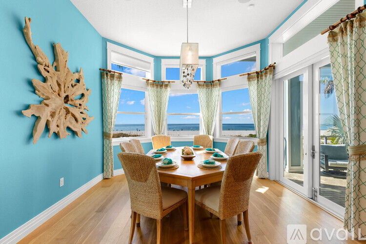 A dining room with a wooden table and chairs.
