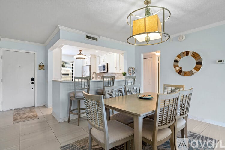A dining room with a table set for four.