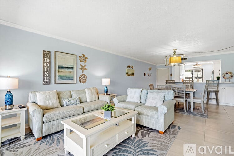 A living room with a white couch and a coffee table.