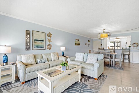 A living room with a white couch and a coffee table.