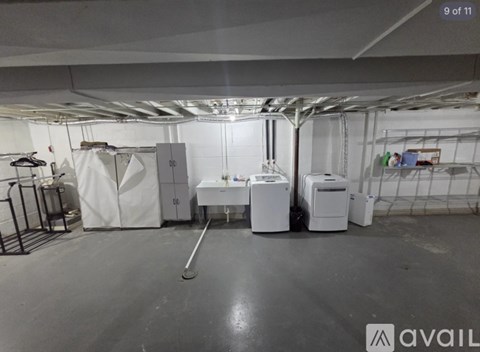 A room with white appliances and a black floor.