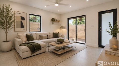 A living room with a white couch and a coffee table.