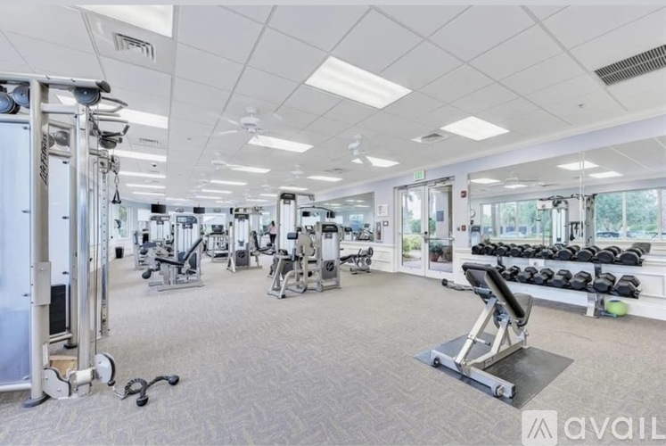 A well-equipped gym with various exercise machines and weights.