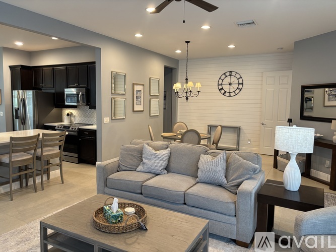 A modern living room with a grey sofa and a wooden coffee table.