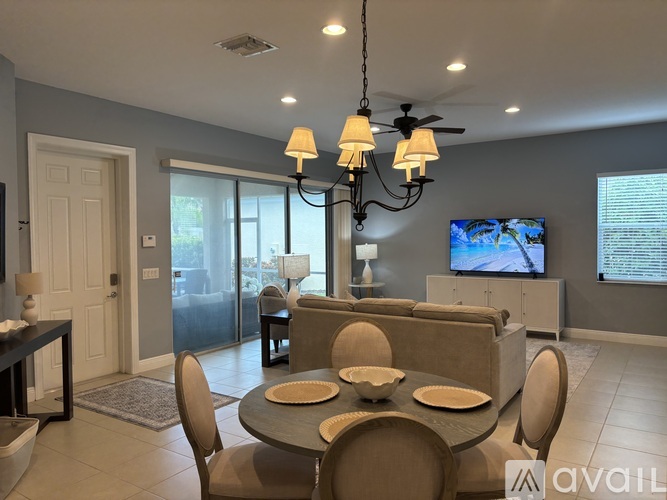 A modern dining room with a glass table and chairs.