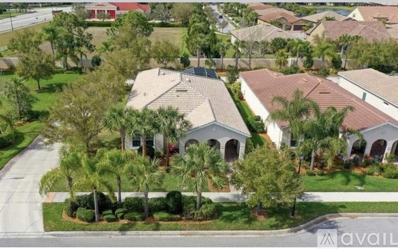 A bird's eye view of a residential neighborhood with houses and trees.