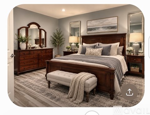 A bedroom with a large bed, a bench, and a dresser with a mirror.