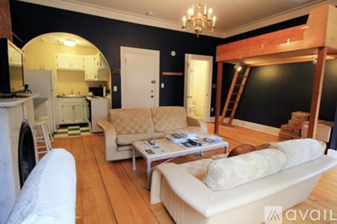 A living room with a white couch and a coffee table.