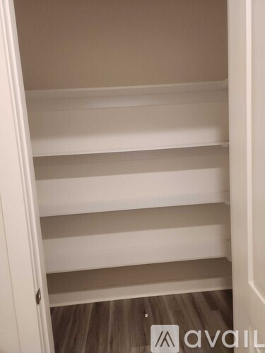 Empty white shelves in a room.