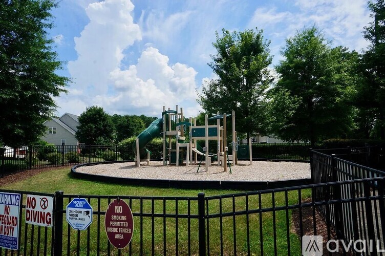 A playground with a green slide and a sign that says "NO DIVING".