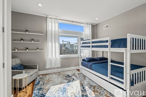 A bedroom with a bunk bed and a window with curtains.