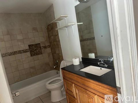 A bathroom with a toilet, sink, and bathtub.