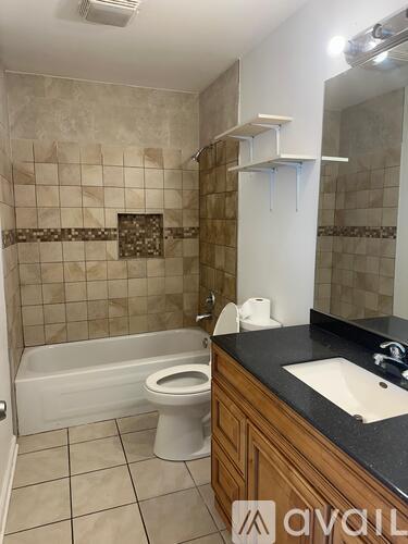 A bathroom with a toilet, sink, and a bathtub.