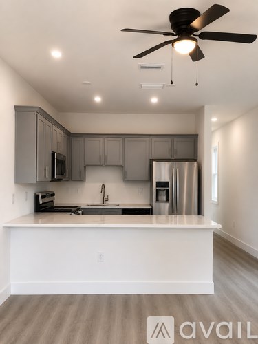 A modern kitchen with a white island and stainless steel appliances.