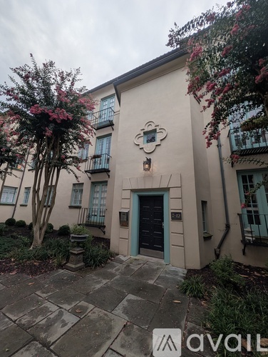 A building with a blue door and a sign that says "avail" in front of it.