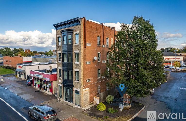 A street view of a building with a car parked in front.
