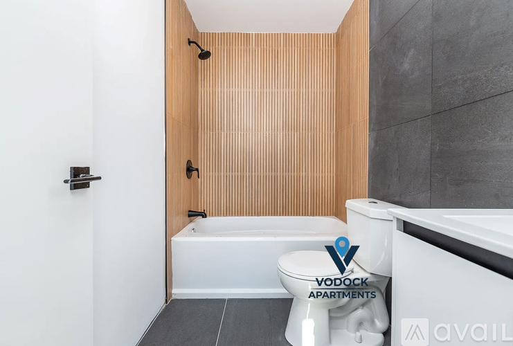 A bathroom with a white bathtub and a white toilet.