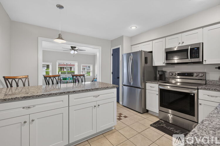 A kitchen with white cabinets and stainless steel appliances.