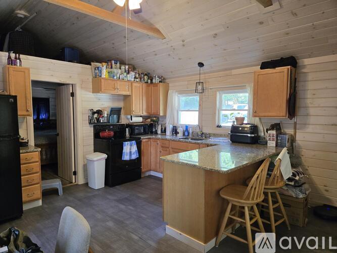 A kitchen with wooden cabinets and a granite countertop.
