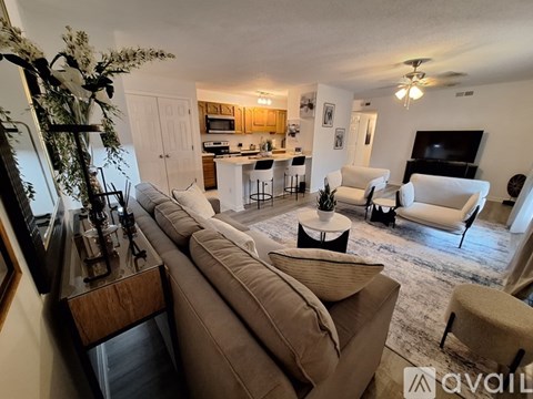 A living room with a brown couch and a television.