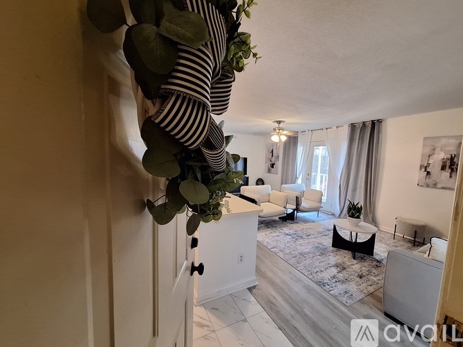 A living room with a striped pillow on the couch.