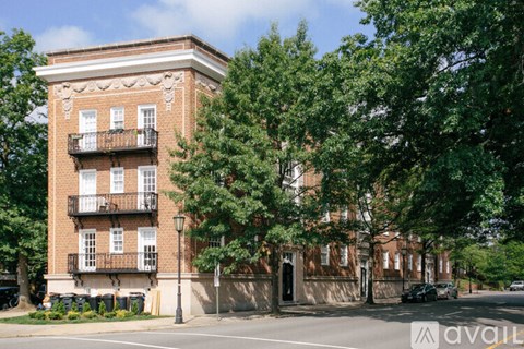 A red brick building with a balcony on the second floor.