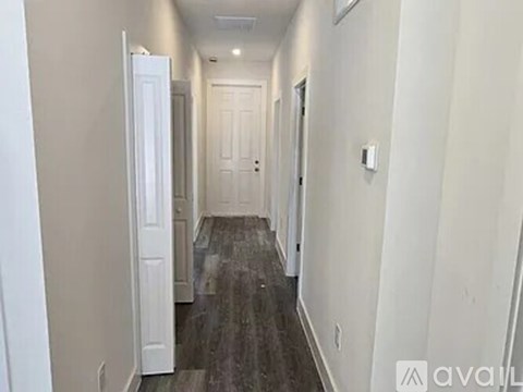 A long hallway with doors on both sides.