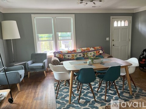 A living room with a grey couch and a white table.