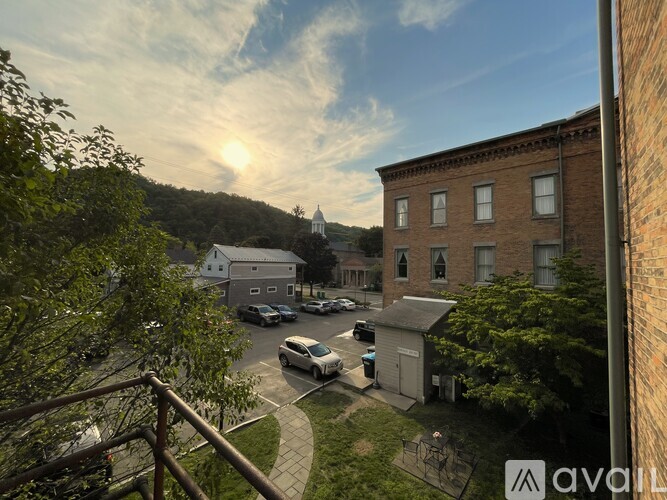 A sunny day in a small town with a church and buildings.