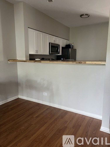 A kitchen area with a microwave and a coffee maker on the counter.