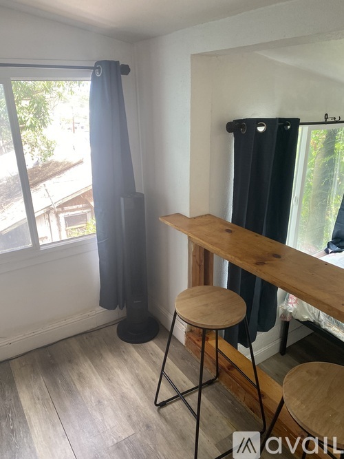 A room with a wooden bar and a black curtain.