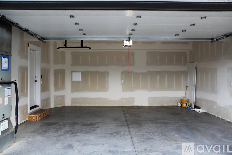 A spacious garage with a concrete floor and walls under construction.