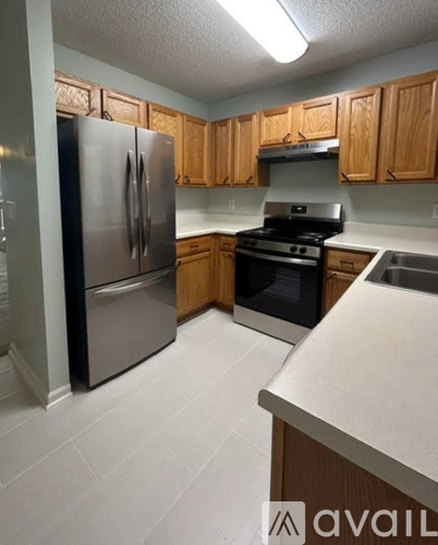 A kitchen with wooden cabinets and a white countertop.