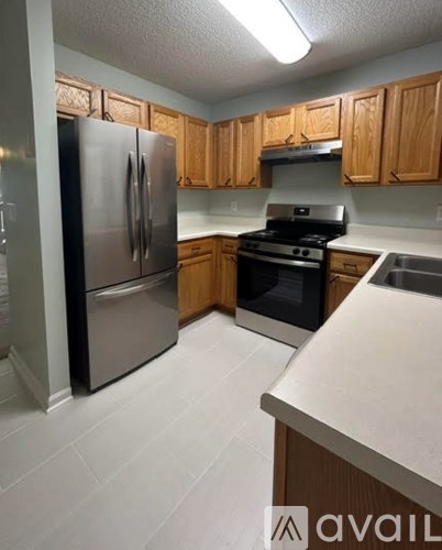 A kitchen with wooden cabinets and a white countertop.