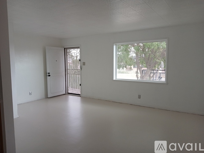 A spacious room with a door and a window.