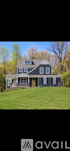 A house with a grey roof and a yellow door.