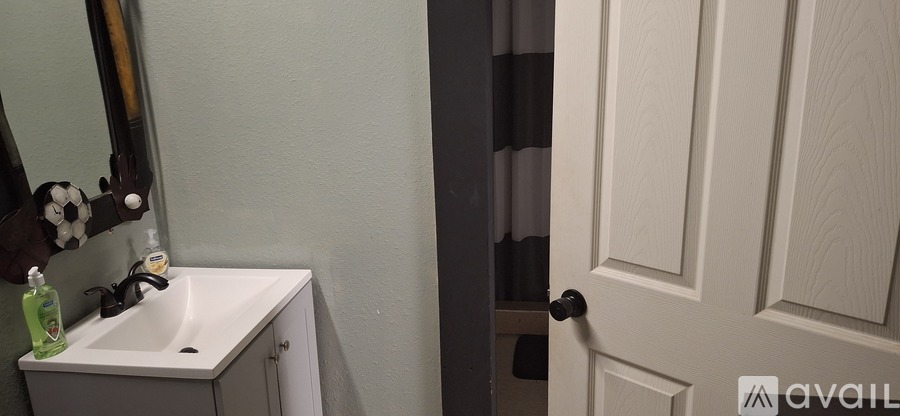 A bathroom with a sink and a mirror.