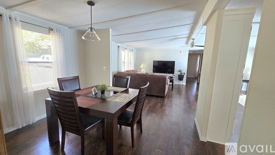 A dining room with a table and chairs is available for rent.